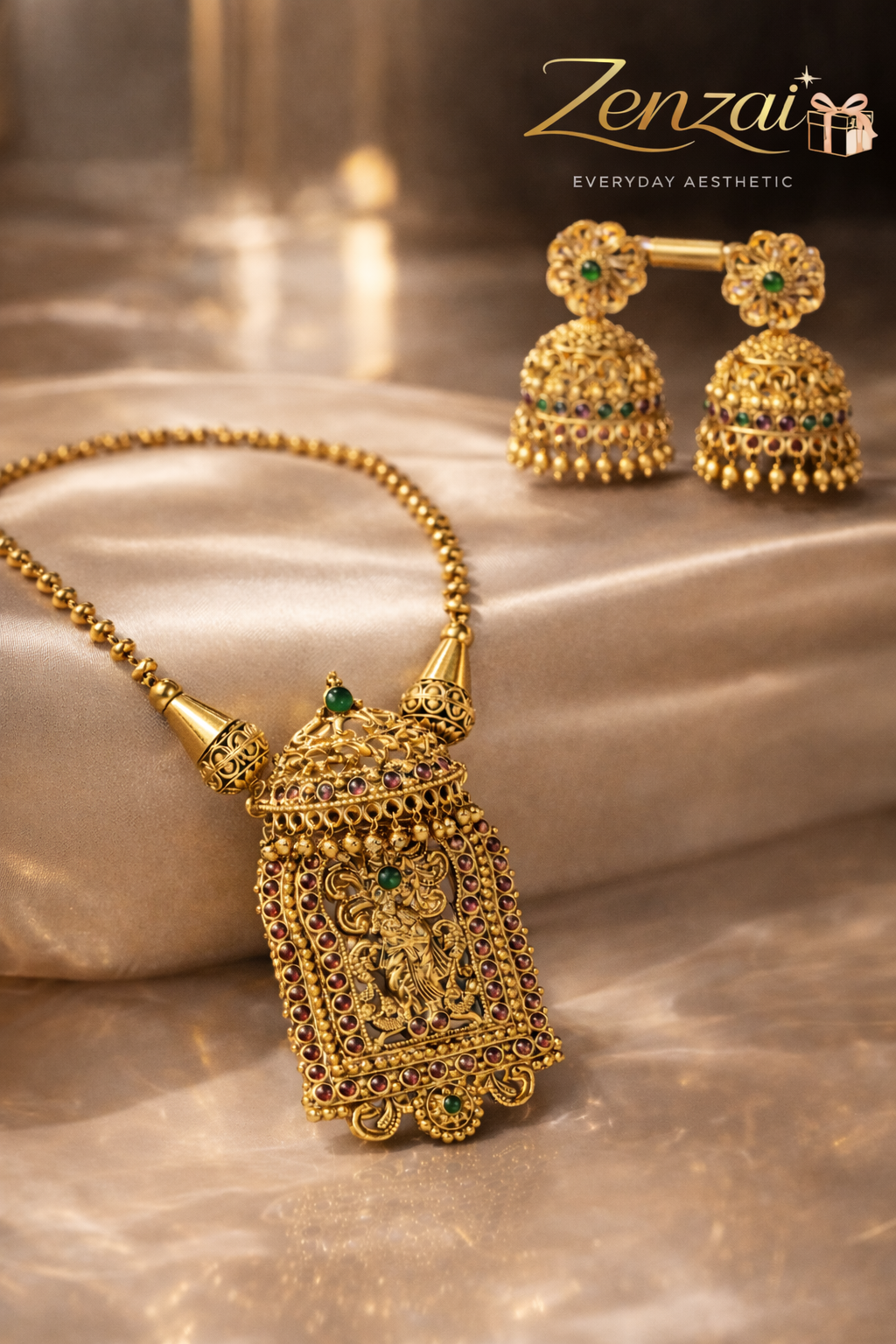 Elegant Zenzai temple jewellery set featuring gold-tone necklace with red stone pendant and green-accented chandbali earrings