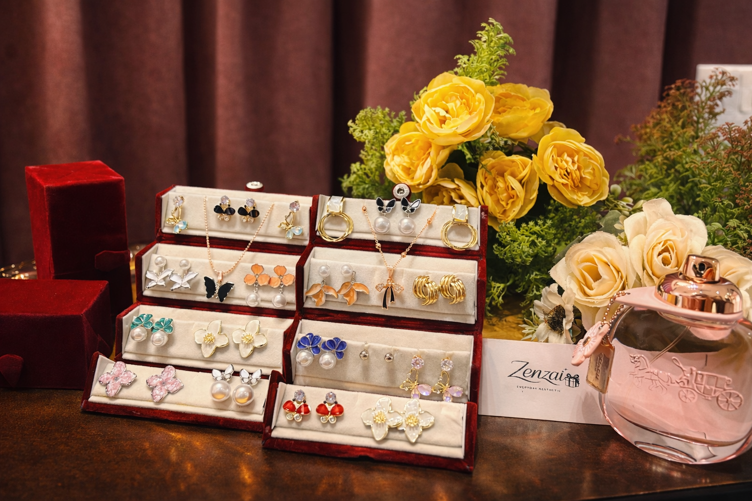 Premium handcrafted jewellery gift set displayed in red velvet boxes with floral enamel earrings, pearls, and gold-tone accents, styled for luxury gifting by Zenzai.